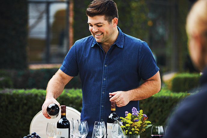 Quilt lifestyle photo featuring Joe Wagner pouring wine at a wine tasting